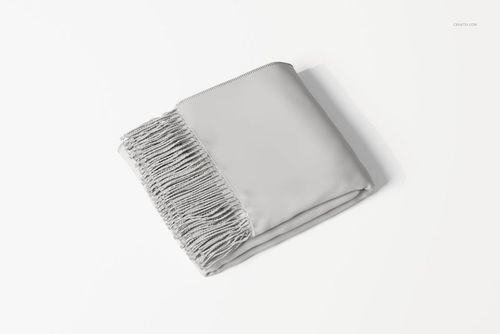 Folded throw blanket in light gray color with fringed edge, shown from a top angle on a plain white background.