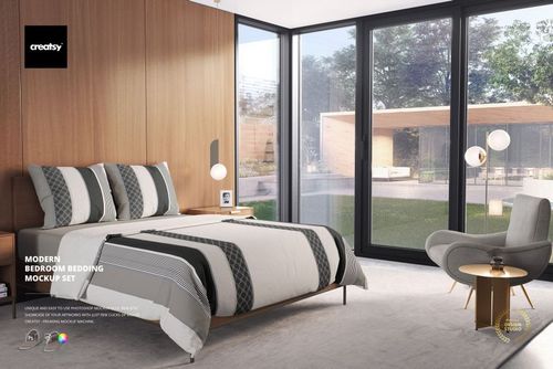 PSD mockup of a sunlit bedroom with geometric bedding, soft rug, accent chair, and outdoor garden view through glass doors.