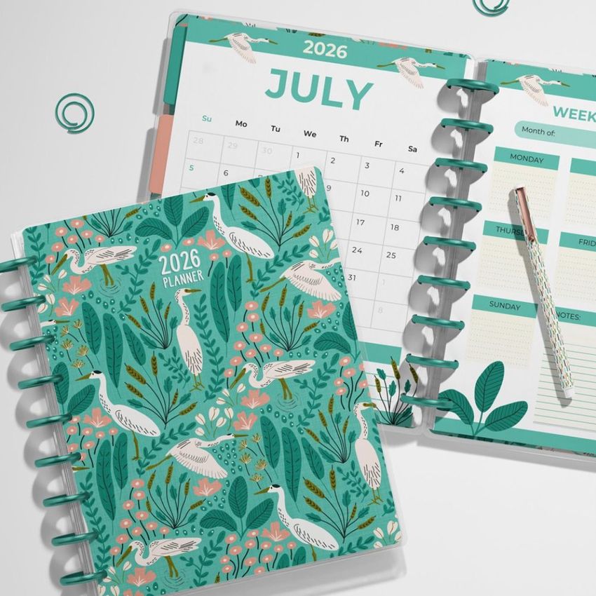 Spiral planner mockup showing a colorful illustrated cover with birds and flowers, next to an open week and month calendar layout.