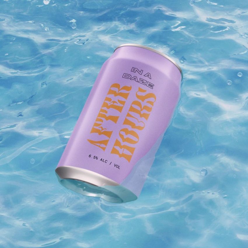 Can in water mockup featuring a pastel purple beverage can with bold yellow and black text, floating on a blue water surface.