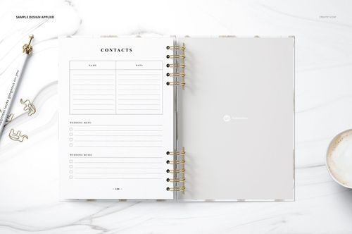 Open spiral-bound planner mockup set on a white surface, featuring blank pages and a contacts section, top view.
