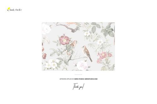 Close-up view of a wrinkled fabric mockup featuring a soft floral and bird pattern on a light background.