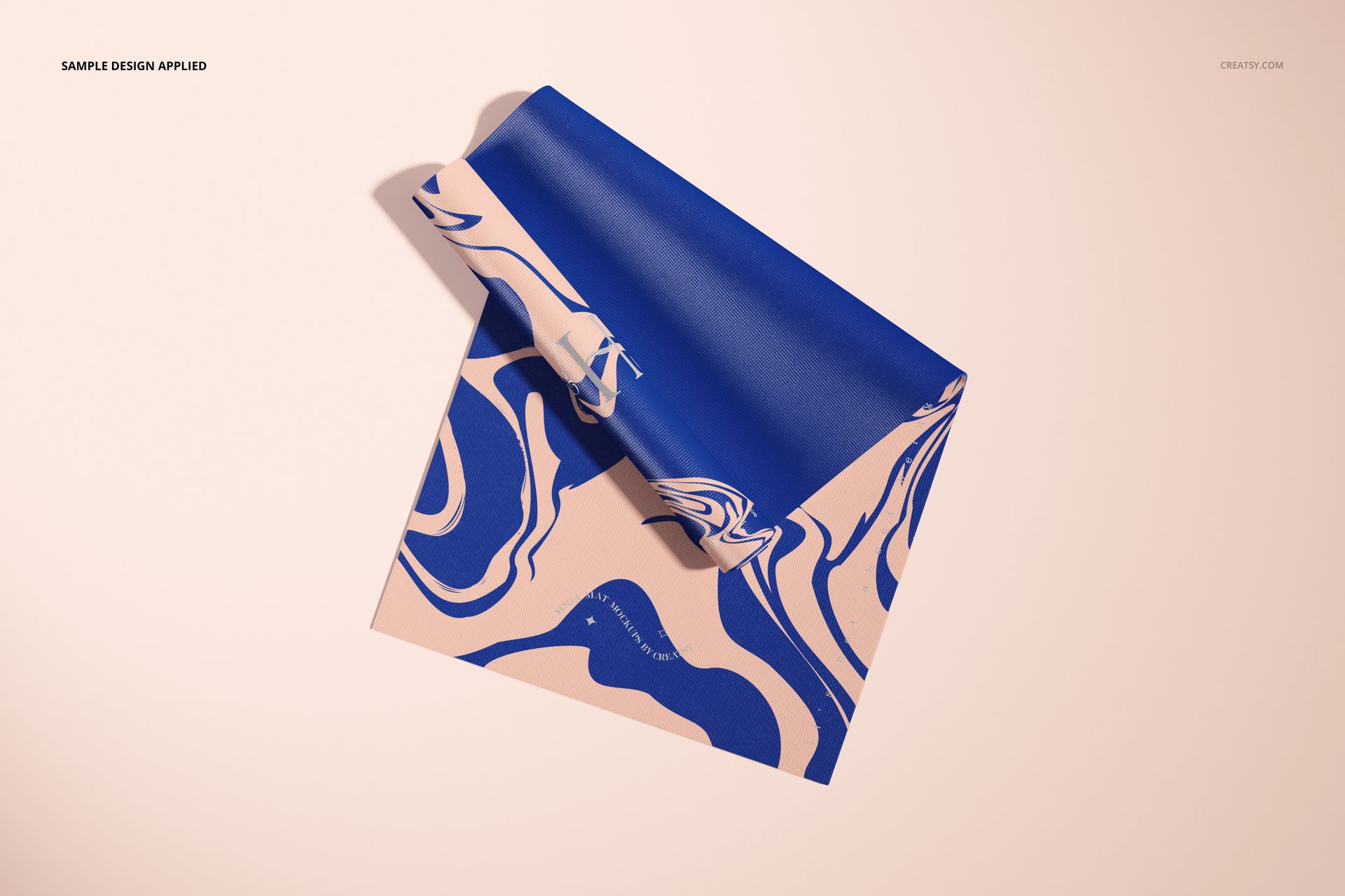 Top view of a yoga mat mockup featuring bold blue marbled design over a light beige base, partially rolled.