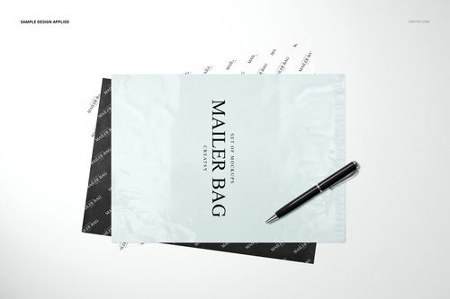 Front view of a mailer bag and wrapping tissue paper mockup set with monochrome designs, pen placed on top.