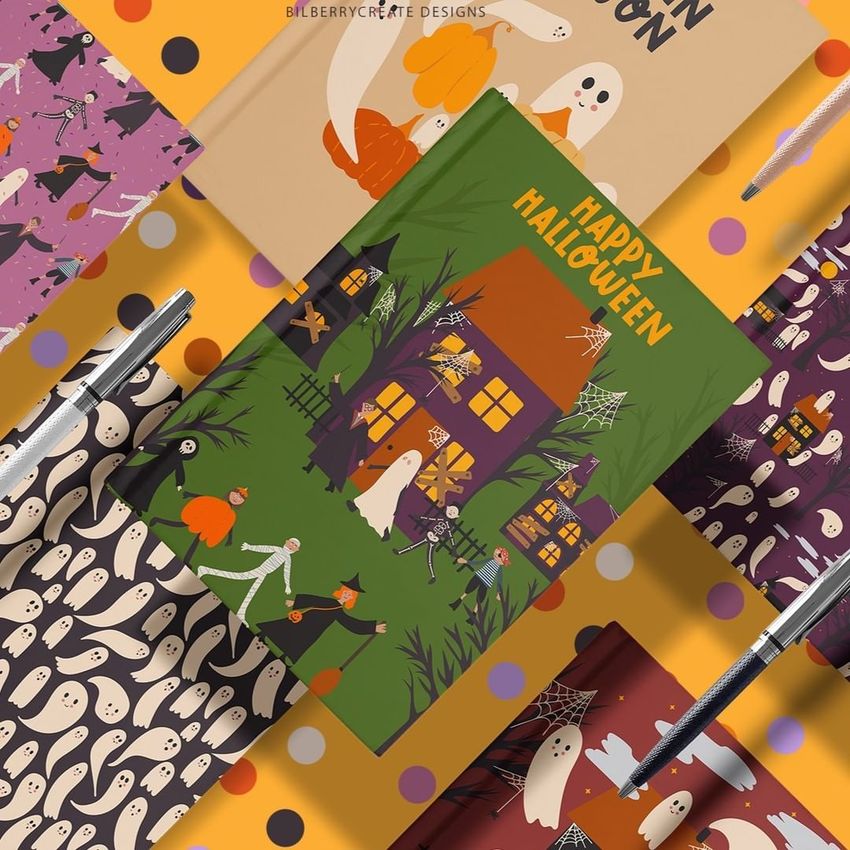 Notebook mockup set featuring Halloween-themed covers with ghosts, pumpkins, and haunted house illustrations, arranged on a polka dot background.