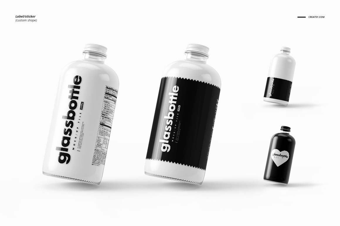 Glass bottle mockup set showing four bottles with monochrome labels, displayed on a clean white surface.