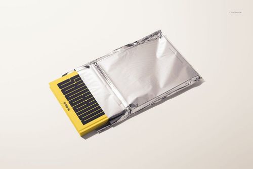 Front view of a hardcover book mockup with a bright yellow cover and black design, half inside a silver sleeve.