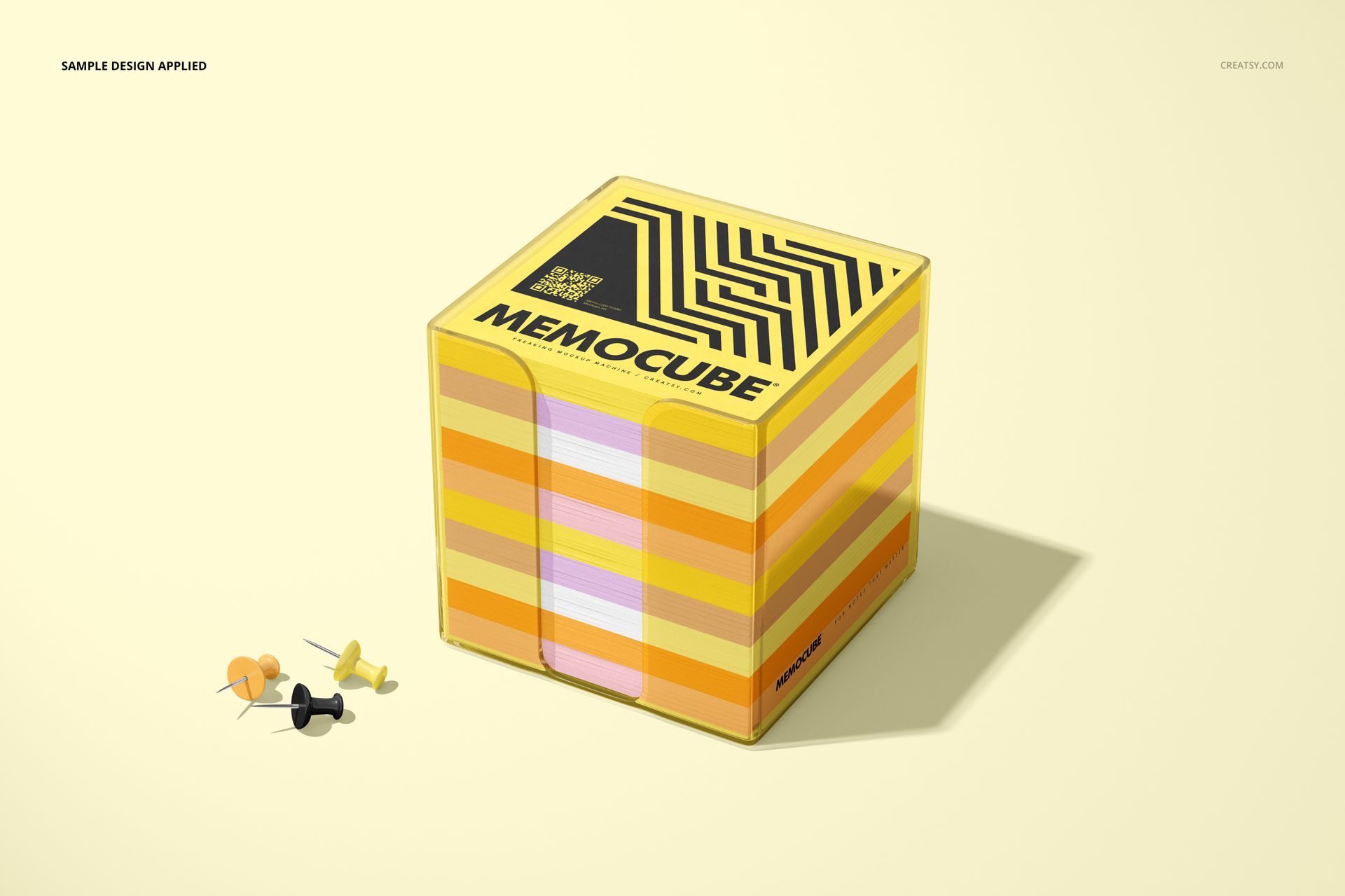 Stationery mockup of a memo block cube in acrylic holder with bold stripes, displayed with push pins on a light surface.