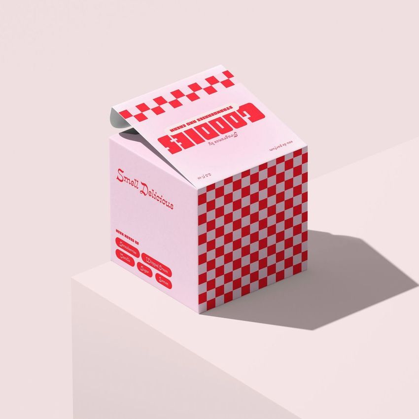 Square box mockup with a pink and red checkered design, photographed on a light surface with soft shadows and an open lid.
