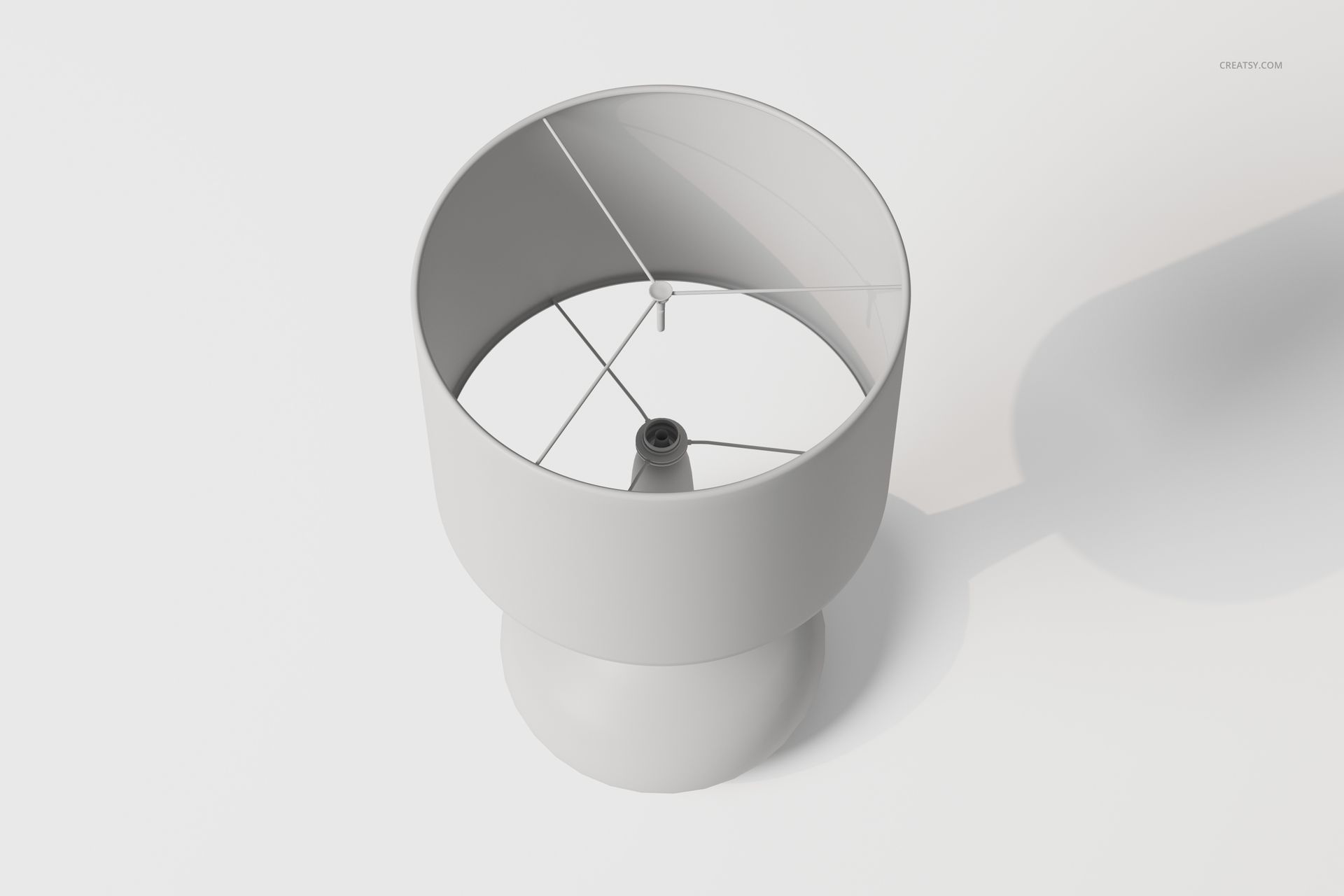 Minimalist bedside table lamp in matte white, viewed from above showing circular shade and central bulb holder.