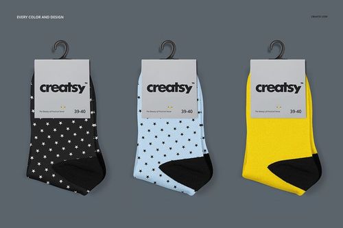 Socks mockup set showing three pairs in black, blue, and yellow with star patterns and black accents, front view.