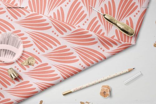Top view of cotton fabric mockup featuring a coral leaf design, accompanied by a seam ripper, pencil, and thimble.