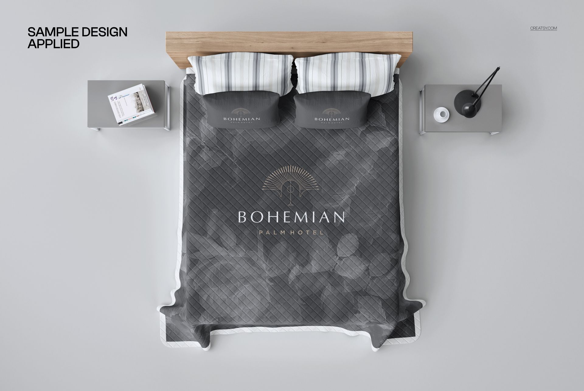 Quilted bed coverlet mockup shown from above, featuring a gray patterned design with matching pillows and modern nightstands.