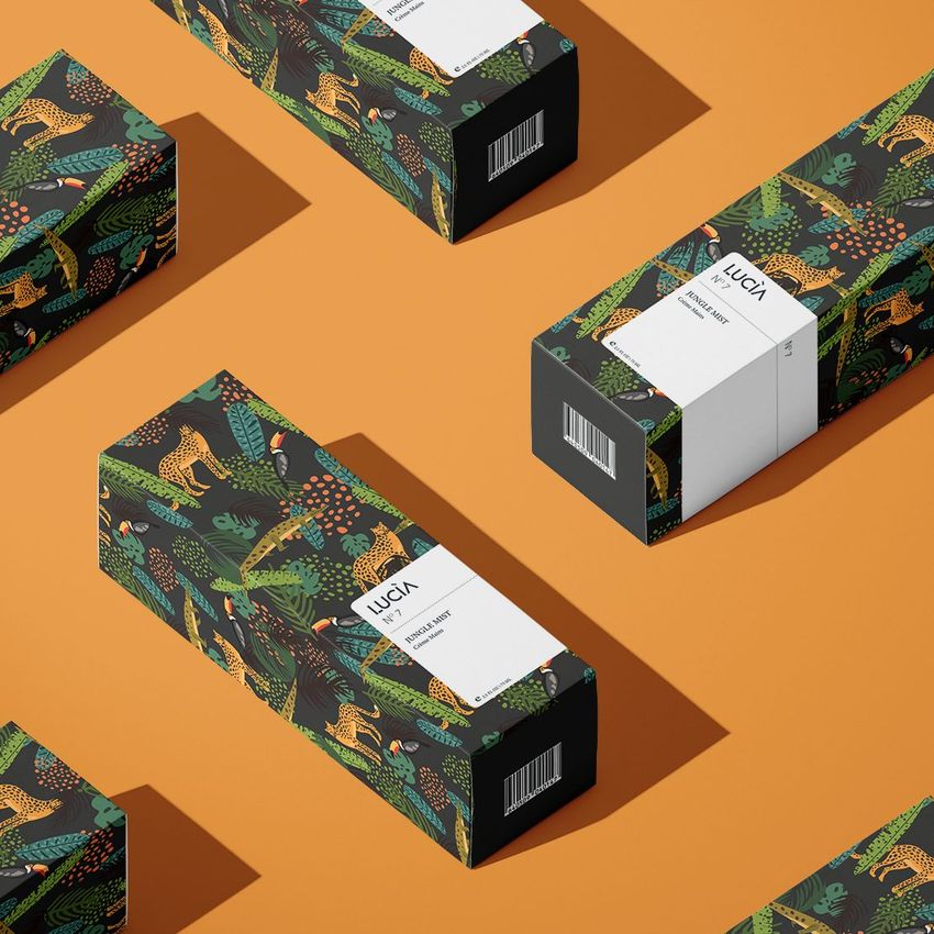 Tall box mockup featuring multiple rectangular boxes with jungle-themed patterns and white labels, arranged on an orange background.