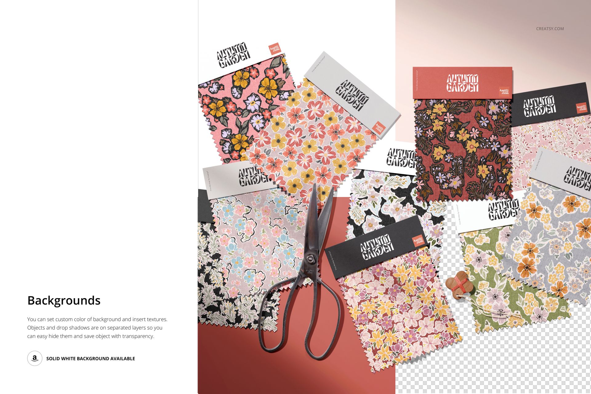 PSD mockup showing various colorful fabric swatches with different designs, some overlapping, and a pair of scissors nearby.