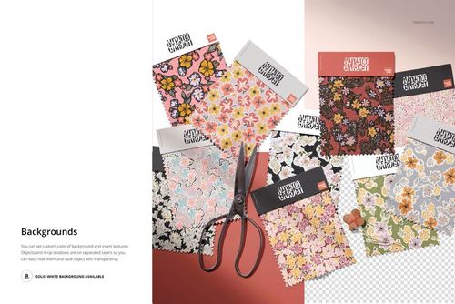 PSD mockup showing various colorful fabric swatches with different designs, some overlapping, and a pair of scissors nearby.