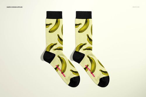 PSD mockup of fashion socks with yellow color, black heel and cuff, and repeating banana motif, top perspective.