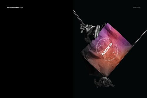 Mockup of a flat handles paper bag featuring a vibrant gradient design, shown in a studio with metal stands.