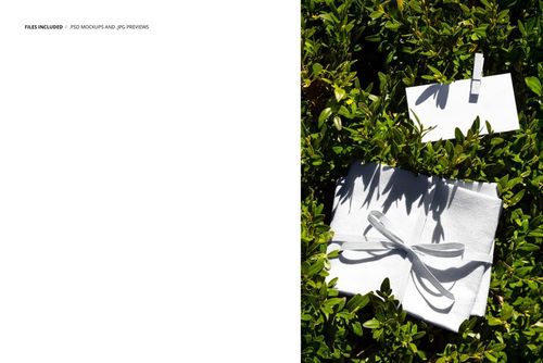 Fabric swatches in white, neatly bundled with a ribbon, and a blank card on a shrub, top view mockup scene.