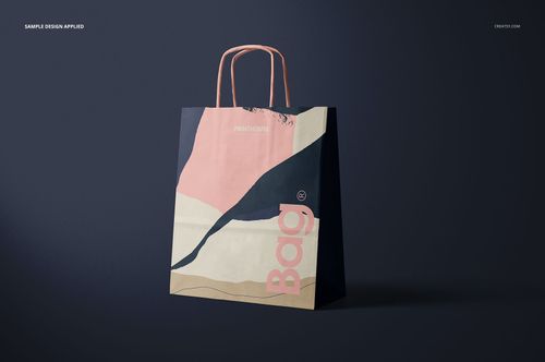 Front view of a twisted handles paper bag with abstract pastel design, standing on a dark surface in a mockup scene.