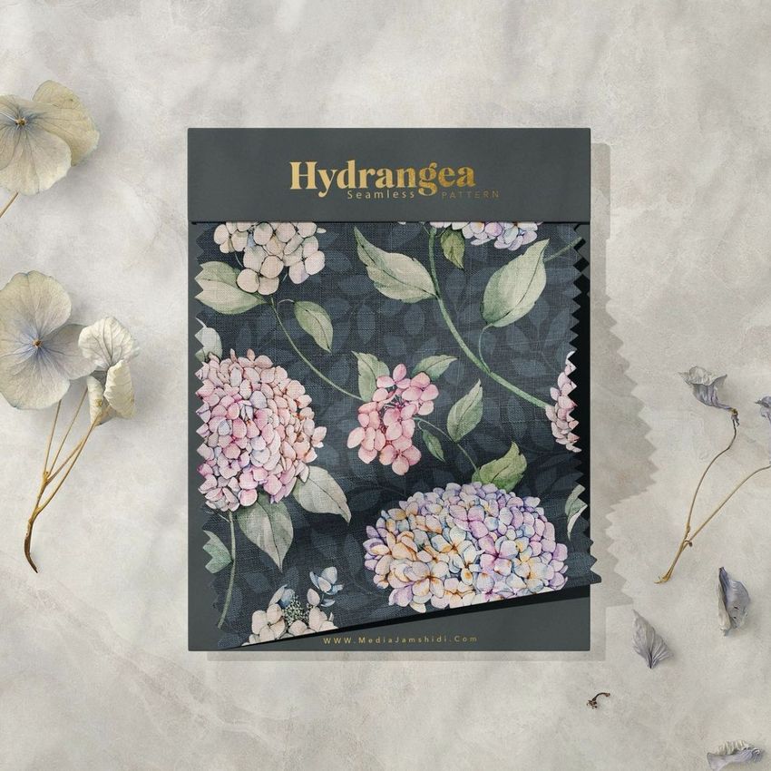 Fabric swatches mockup featuring a floral hydrangea pattern on dark fabric, displayed on a textured light surface with dried flowers.