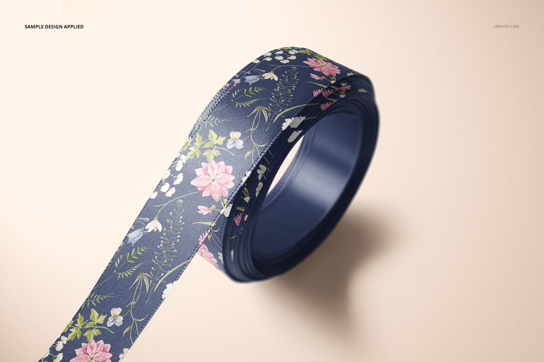 PSD mockup showing a single ribbon roll with a detailed floral print, viewed from an angled perspective.