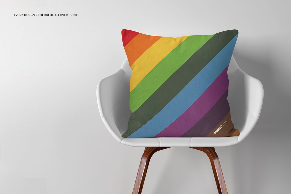 Colorful striped throw pillow mockup displayed on a white chair, featuring diagonal rainbow pattern and neutral setting.