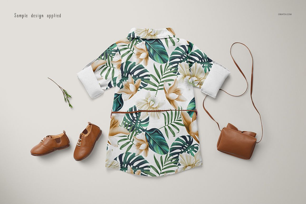 Baby jeans dress mockup featuring a floral and leaf print, displayed alongside brown shoes and a small purse.