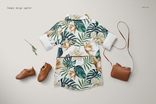 Baby jeans dress mockup featuring a floral and leaf print, displayed alongside brown shoes and a small purse.