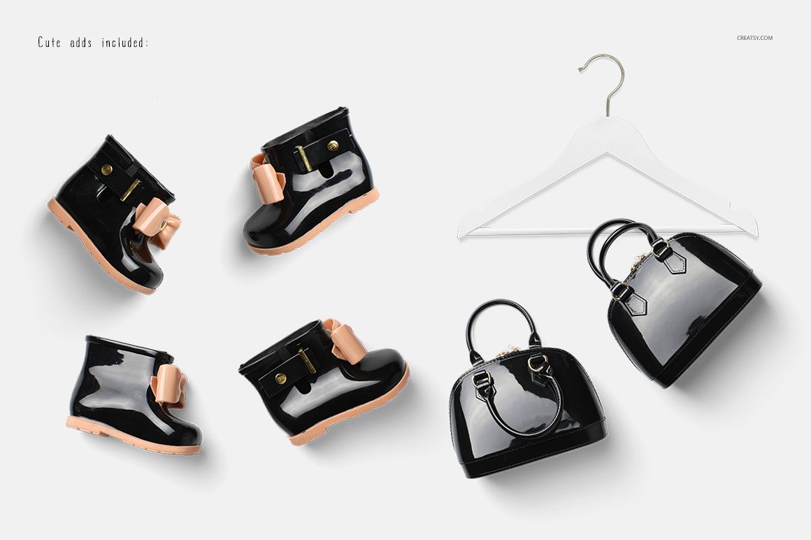 PSD mockup featuring black baby boots with pink accents, a black purse, and a white hanger displayed from above.
