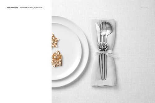 PSD mockup showing a festive table with white plates, decorative cookies, and silver cutlery tied with a pinecone ribbon napkin.