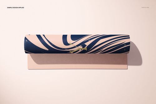Top view of a yoga mat mockup featuring a bold blue and beige wavy design, partially unrolled on a light surface.