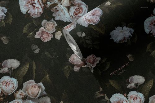 Close-up of a non-woven vinyl wallpaper mockup roll displaying detailed rose flowers and green leaves on a textured surface.