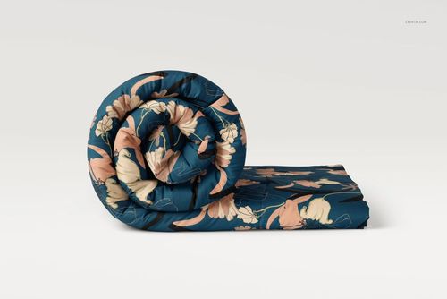 Microfiber comforter mockup featuring a rolled design, decorated with peach and cream flowers on a navy blue base.