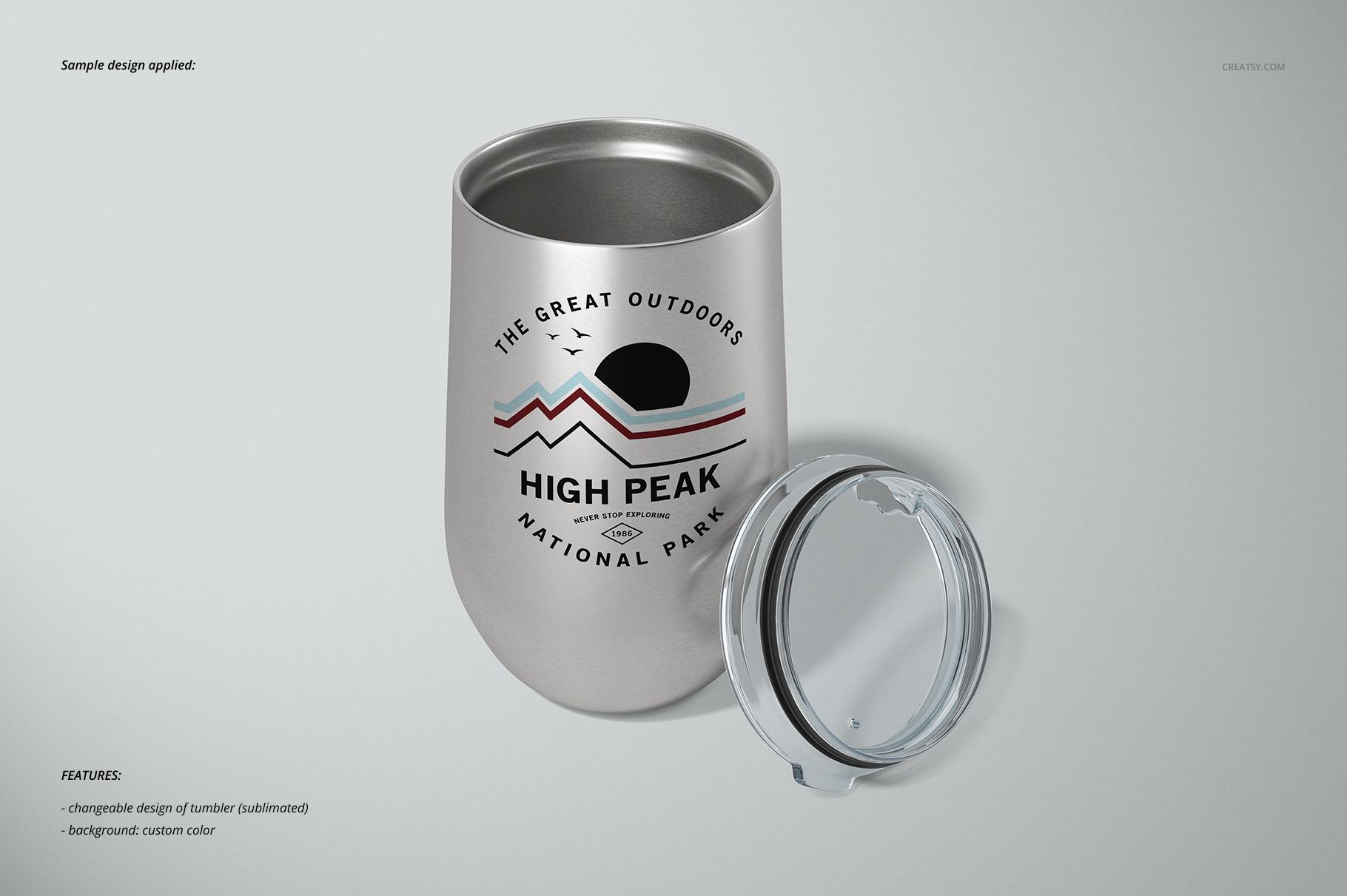 Front view of a silver stemless wine cup with a removable clear lid, featuring a mountain-themed design on a plain background.