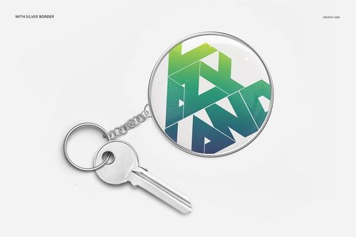 PSD mockup of a circular key chain attached to a silver key, displaying an abstract green and blue design on white.