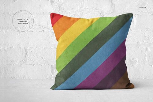 Colorful pillow mockup featuring diagonal rainbow bands on a square shape, set in front of a textured white wall.