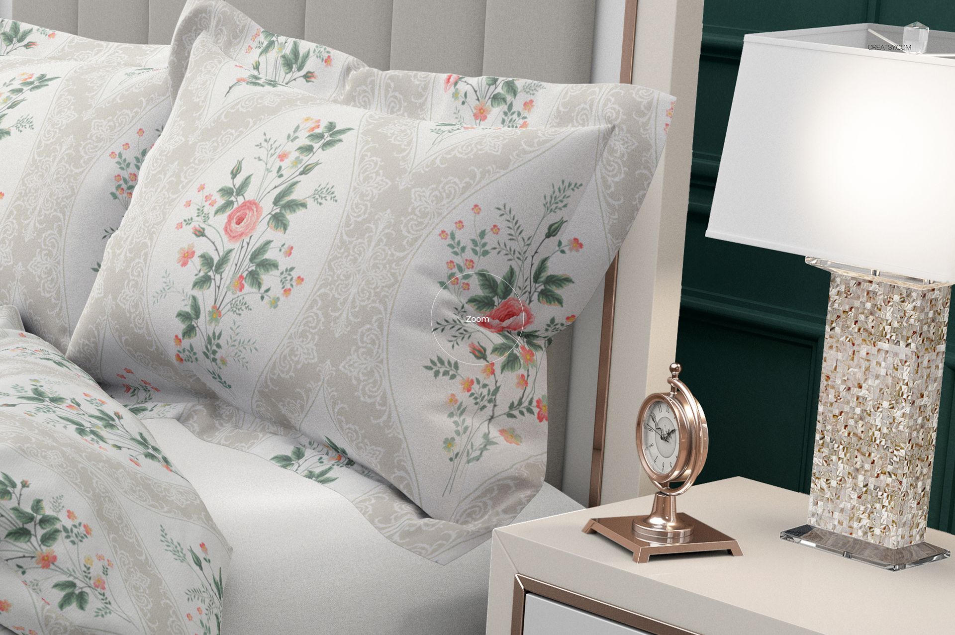 Close-up of a bedding mockup with flanged pillows showing pastel floral designs, next to a lamp and clock.