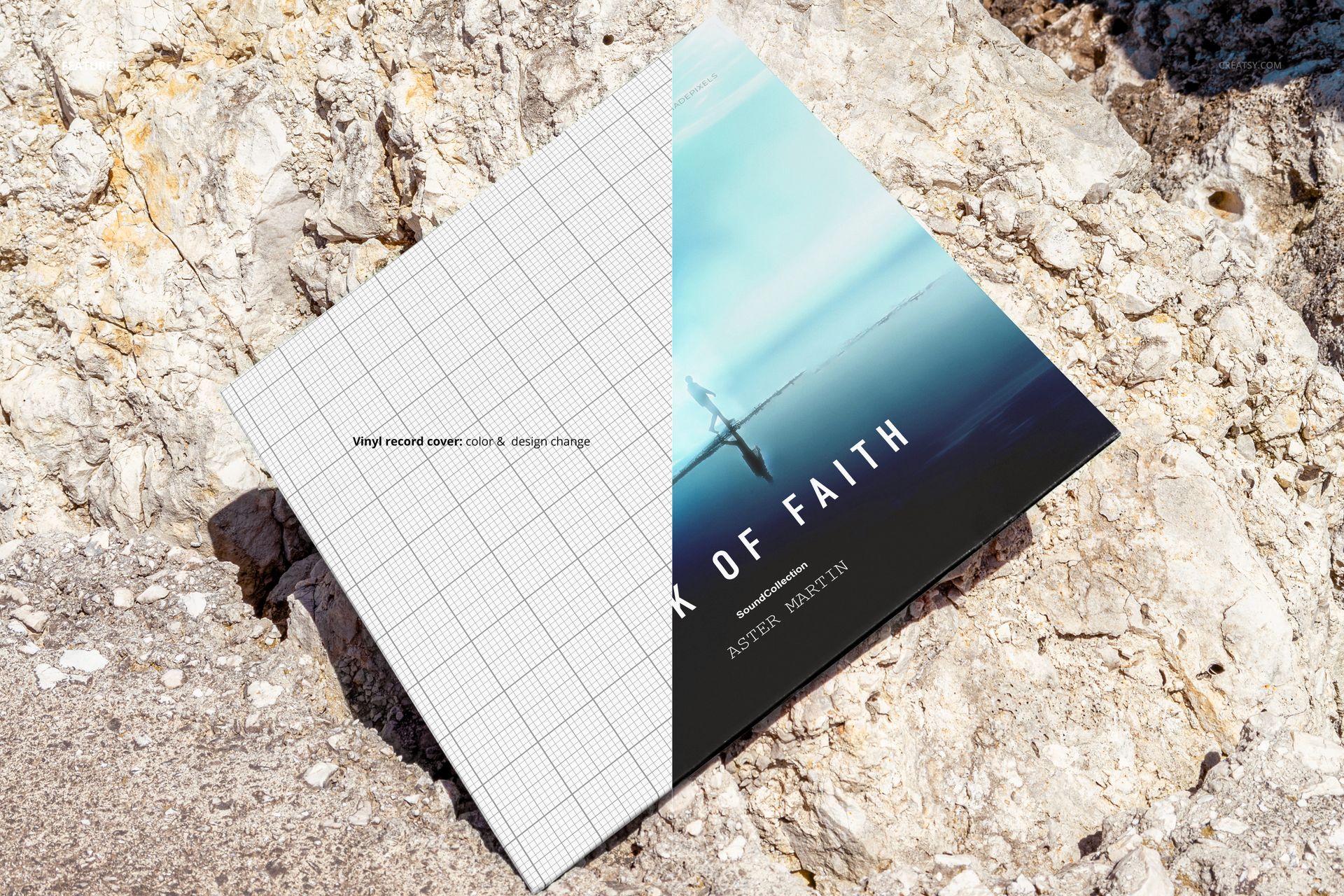 Vinyl record cover mockup placed on rocky coast, showing split design with grid pattern and ocean scene.