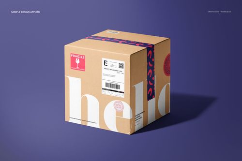 Mockup of a shipping box with visible stickers and patterned tape, photographed from an angled front perspective.