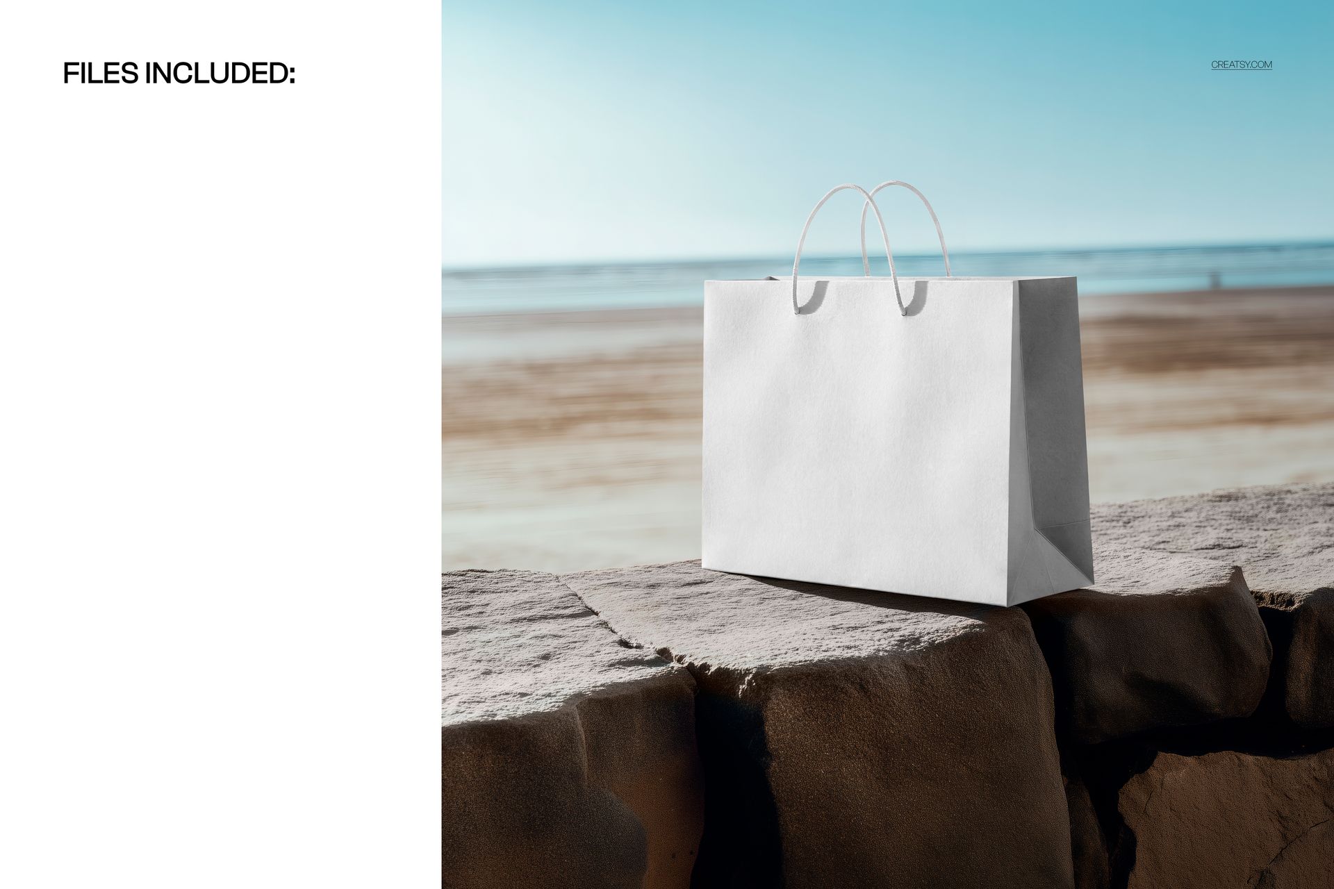 White horizontal shopping bag mockup on a stone ledge by the beach, ocean and blue sky visible in the distance.
