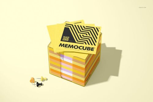 Yellow memo block cube mockup in an acrylic holder, with geometric patterned notes and assorted push pins nearby.