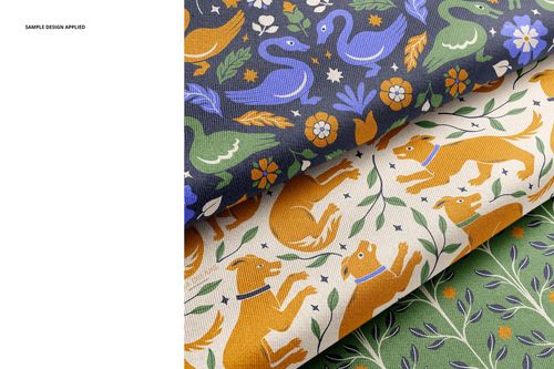 Stacked twill silk fabrics in a mockup, featuring playful dog, swan, and bird designs with floral accents.