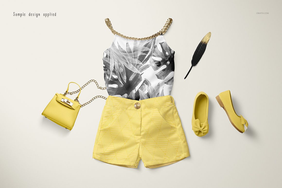 Front view of a baby summer set mockup featuring a sleeveless top with leaf pattern, yellow shorts, matching shoes, and a small purse.