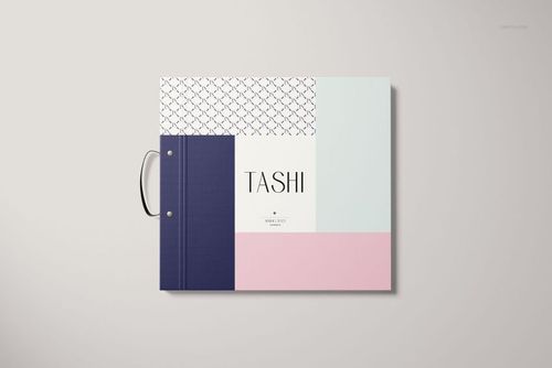 Front view of a wallpaper sample book mockup with a metal ring binder and geometric pastel color blocks on the cover.