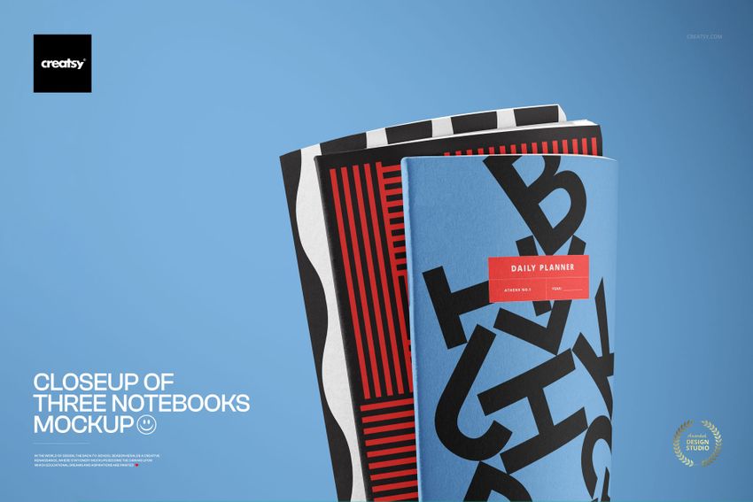 PSD mockup featuring three modern notebooks with abstract patterns and vivid colors, displayed from a front angle.