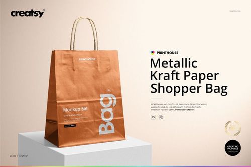 Front view of a metallic kraft paper shopping bag mockup with a copper finish, standing on a light surface.