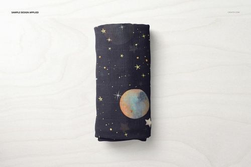 Muslin swaddle blanket mockup rolled up, decorated with celestial moon and star motifs, viewed from above.