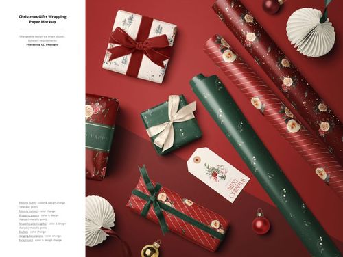 Top view of Christmas gift wrapping mockup featuring decorated boxes, paper rolls, baubles, and a holiday tag.