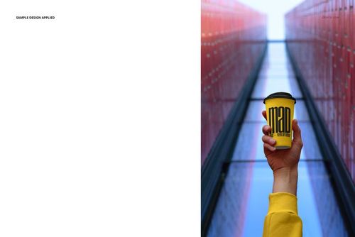 Yellow paper cup mockup with black lid, held up by a person in a yellow sleeve, set against modern city architecture.